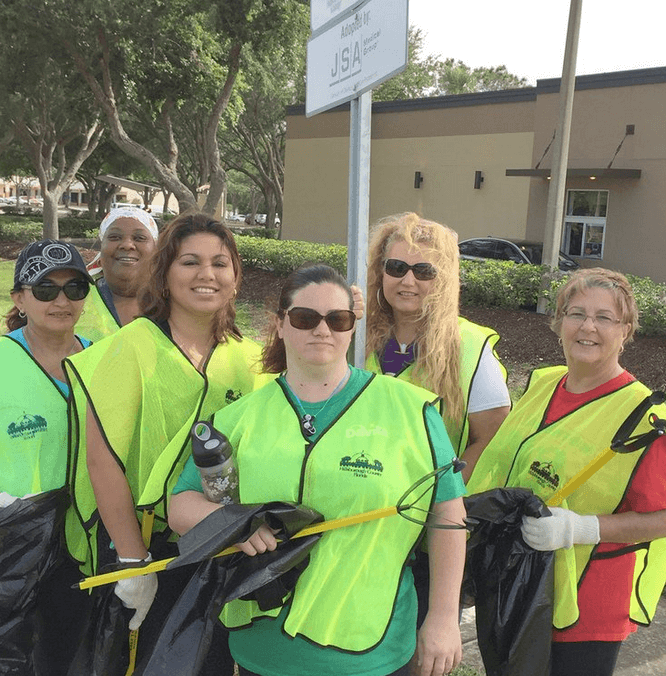 five volunteers at a park cleanup project